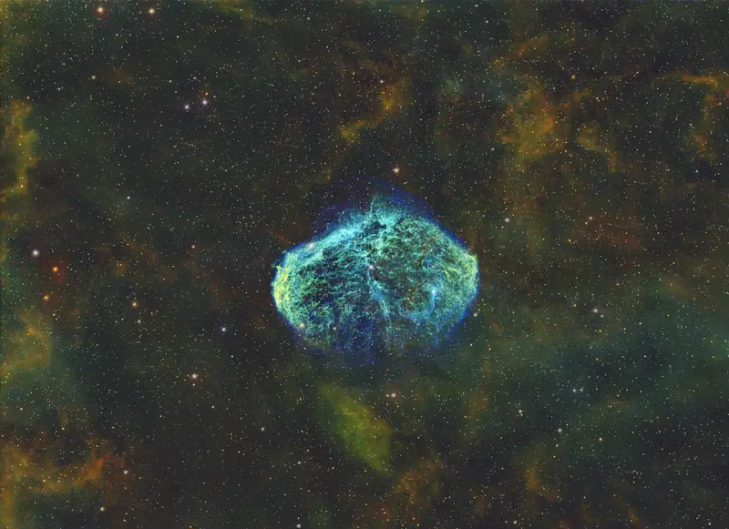 The Crescent Nebula, a bright shell of gas inside a wider field of faint oxygen emission