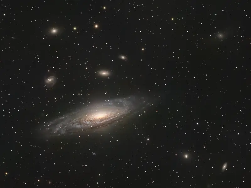 NGC 7331, an inclined spiral galaxy with a group of fainter galaxies nearby